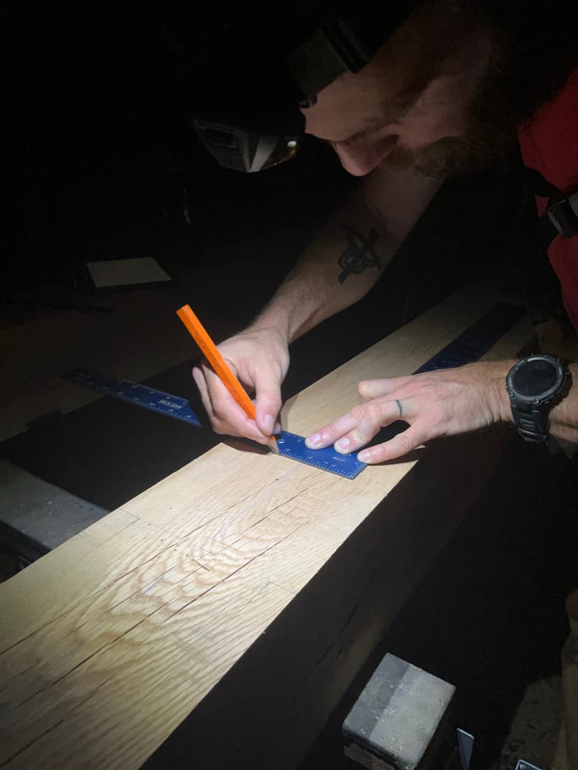 Michael marking timber on a job site